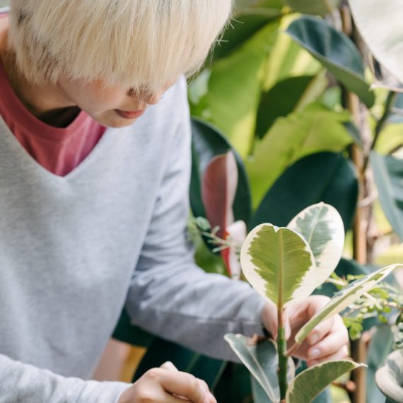 A girl in garden fixing a pot